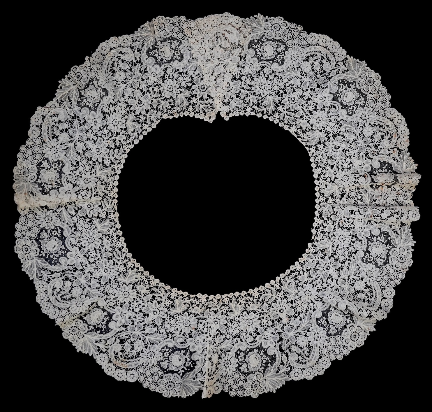 An 1860’s unused, large circular flounce shaped collar of mixed Brussels bobbin lace, with twelve needle lace Point de Gaz insertions, 18.5cm deep, approximately 248cm along bottom, edge. Condition - good